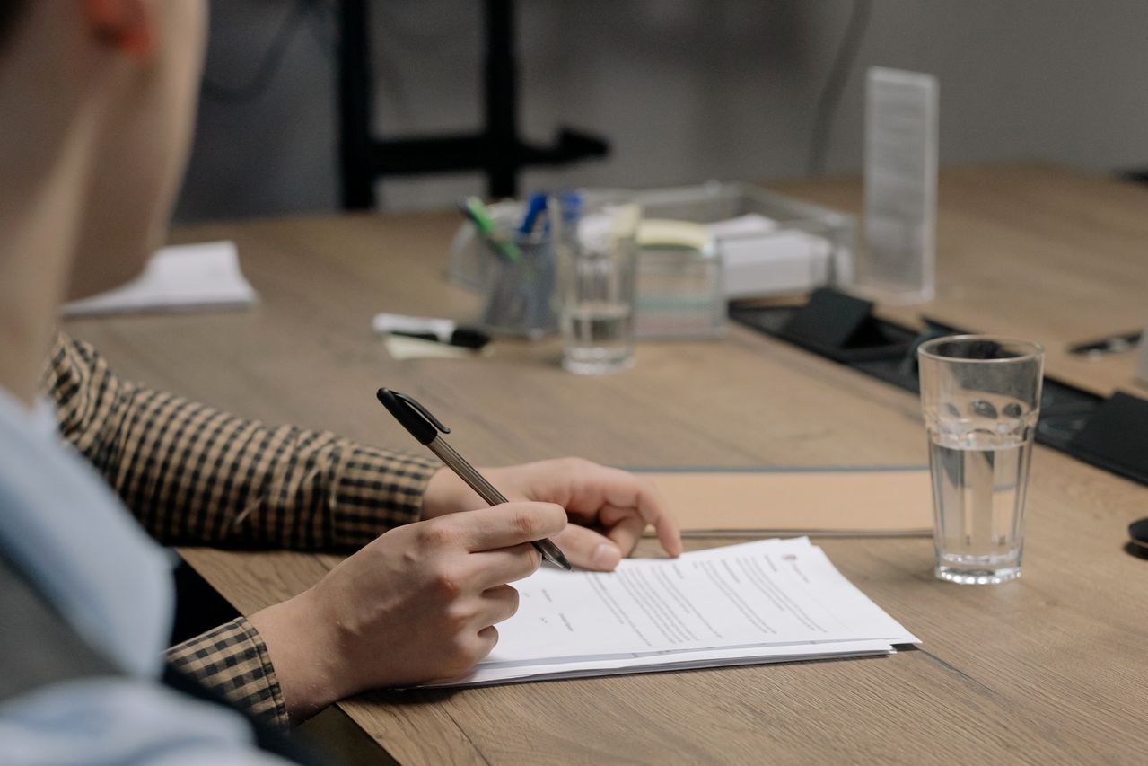 Person reviewing financial documents after completing debt counselling